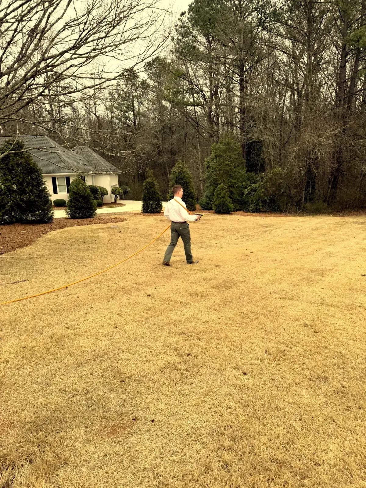Lawn treatment in progress at Bonaire GA residential property