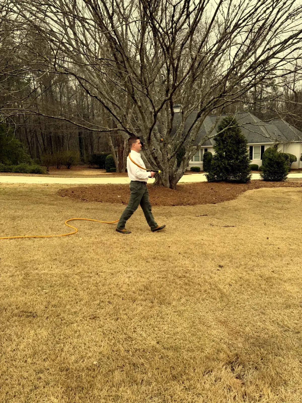 Attaboy Lawn Care technician treating a residential lawn in Central Georgia