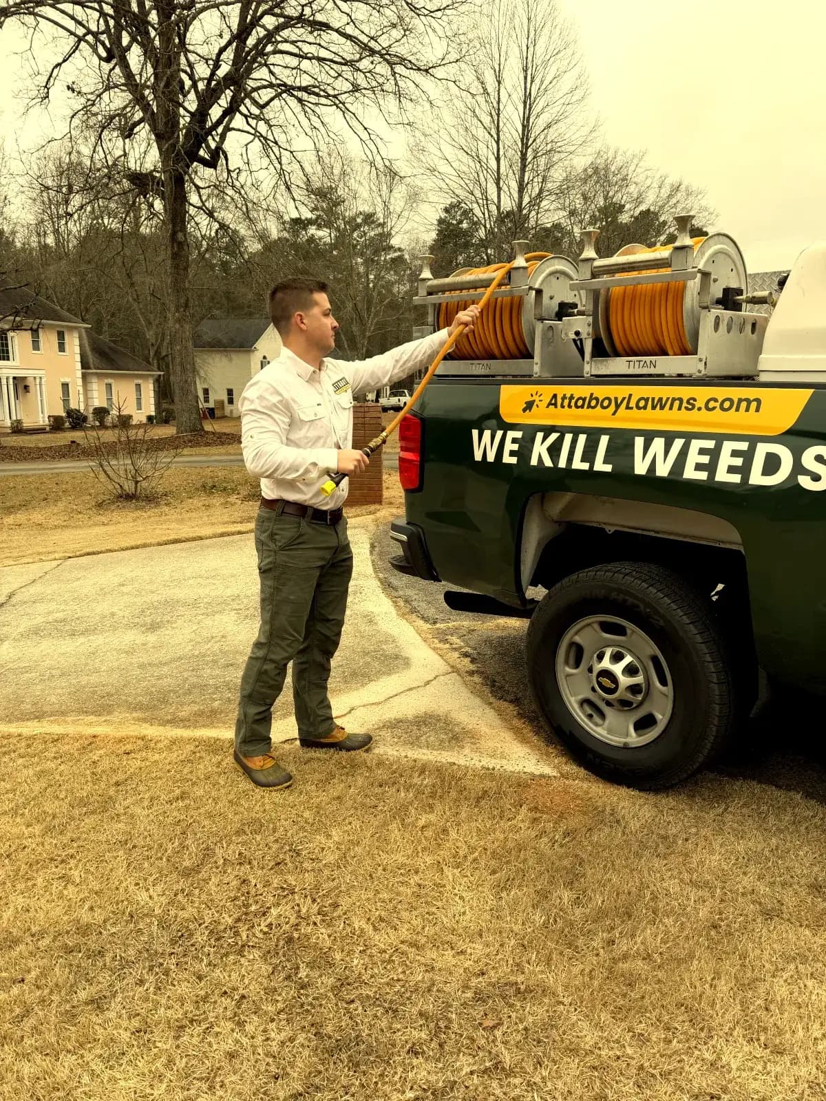 Lawn care technician heading to treat a Warner Robins lawn