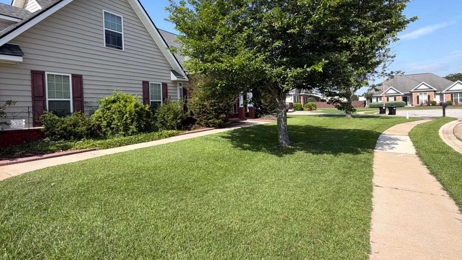Thick green lawn in front of an Attaboy Lawn Care customer's home in Middle Georgia